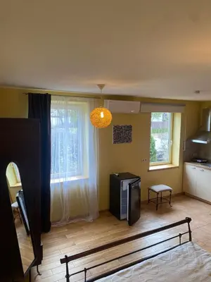 a living room with a couch and a television in it at Gudyno in Kaunas