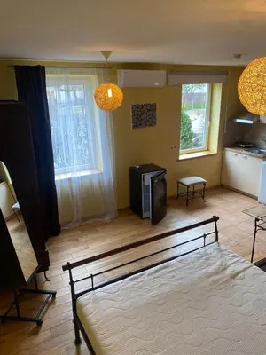 a room with a bed and a television in it at Gudyno in Kaunas