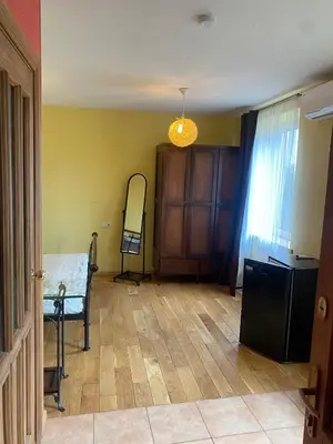 an empty living room with a table and a chair at Gudyno in Kaunas