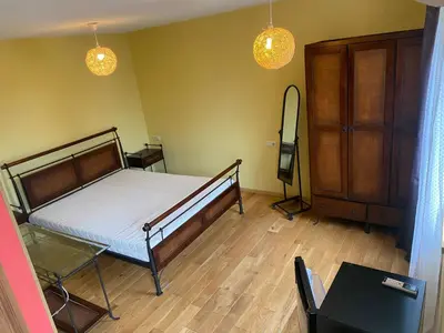 a bedroom with a bed and a tv in it at Gudyno in Kaunas