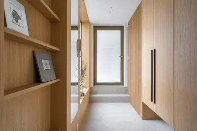 a hallway with wooden walls and a window and a door at Cozy one bedroom apartment in Vilnius Old Town in Vilnius