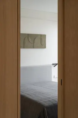 a bedroom with a bed in a white room at Cozy one bedroom apartment in Vilnius Old Town in Vilnius