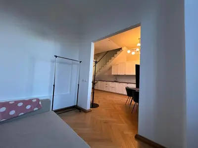 a living room with a couch and a dining room at Vydūno apartamentai 10 in Kaunas