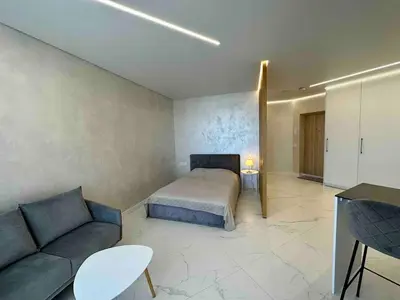 a bedroom with a bed and a couch at New luxury modern Apartment in Šnipiškės in Vilnius