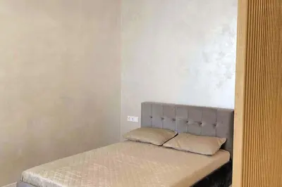 a bed with two pillows on it in a room at New luxury modern Apartment in Šnipiškės in Vilnius