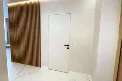 a glass door in a room with a wall at New luxury modern Apartment in Šnipiškės in Vilnius