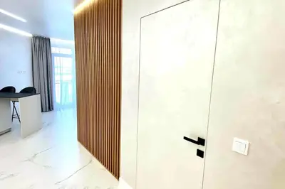 a door in a room with a table and chairs at New luxury modern Apartment in Šnipiškės in Vilnius
