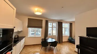 a kitchen with a table and chairs in a room at Vydūno apartamentai 8 in Kaunas