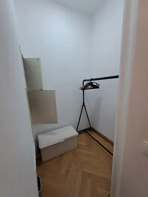 a room with a white wall and a room with a table at Vydūno apartamentai 8 in Kaunas