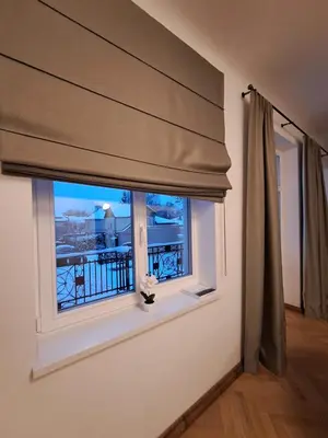a window with a curtain and a view of a balcony at Vydūno apartamentai 8 in Kaunas