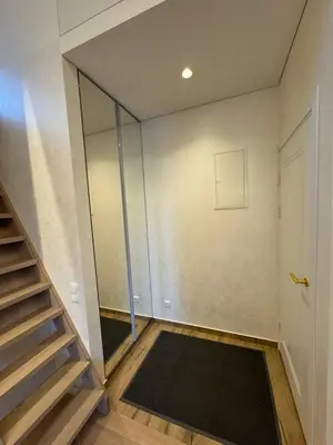 a room with a staircase and a glass wall at Ajeru Apartments in Kaunas