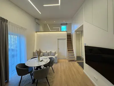 a living room with a table and chairs and a couch at Ajeru Apartments in Kaunas