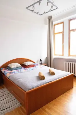 a bedroom with a bed with two teddy bears on it at Vilnius Old Town Riverside Apartment in Vilnius