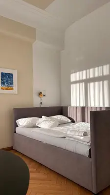 a large bed in a room with a window at Vydūno apartamentai 5 in Kaunas