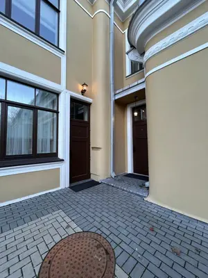 a hallway of a building with two doors and a rug at Vydūno apartamentai in Kaunas