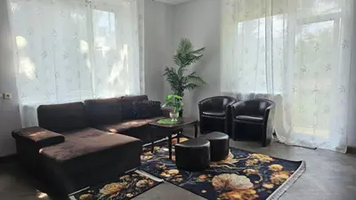 a living room with a couch and a table and chairs at Dviejų kambarių butas Kauno centre in Kaunas