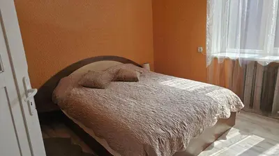 a bed with two pillows on it in a bedroom at Dviejų kambarių butas Kauno centre in Kaunas