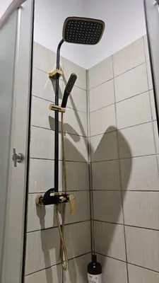 a shadow of a shower head in a shower stall at Dviejų kambarių butas Kauno centre in Kaunas