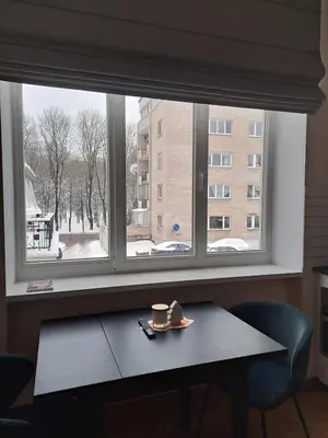 a window with a table and a cup of coffee on it at Vyduno apartamentai 11 in Kaunas