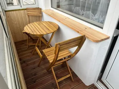 a small table and a bench on a tiny house at Konarskio 3 kambarių butas in Vilnius