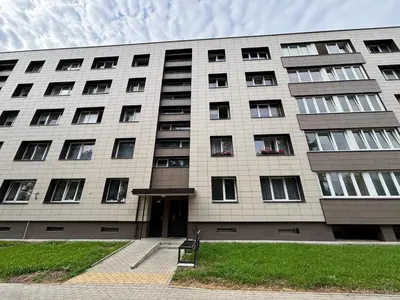 a large building with windows and a door at Butas Putinuose in Alytus