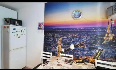 a kitchen with a picture of the eiffel tower at Butas Putinuose in Alytus