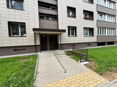 a building with a bench in front of it at Butas Putinuose in Alytus