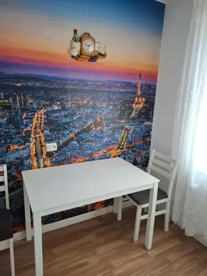 a white table in a room with a view of the city at Butas Putinuose in Alytus