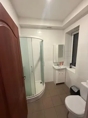 a bathroom with a shower and a toilet and a sink at Bernotiškių Hotel & Dining