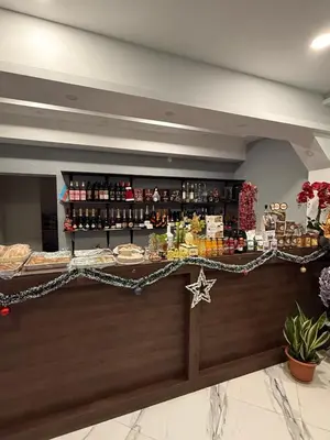 a lobby with a counter with food and drinks at Bernotiškių Hotel & Dining