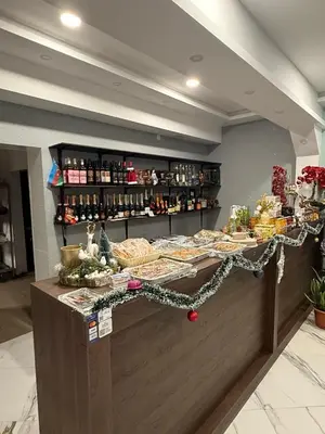 a food counter in a store with christmas decorations at Bernotiškių Hotel & Dining