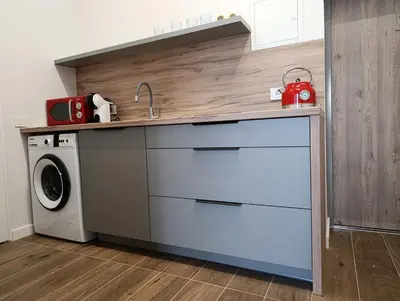a kitchen with a sink and a washing machine at Park&Stay First Floor Loft Panevėžys in Panevėžys