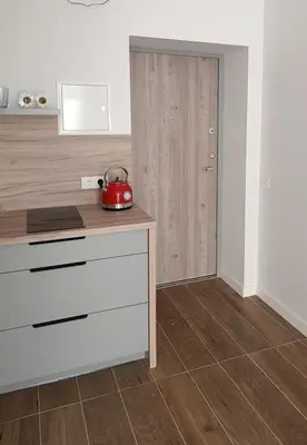 a kitchen with a red tea kettle on a counter at Park&Stay First Floor Loft Panevėžys in Panevėžys