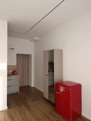 a kitchen with a red refrigerator in a room at Park&Stay First Floor Loft Panevėžys in Panevėžys