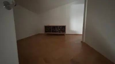 an empty room with a wooden floor and white walls at Vydūno apartamentai 12 in Kaunas
