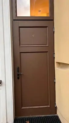 a brown door with a window on top of it at Vydūno apartamentai 12 in Kaunas