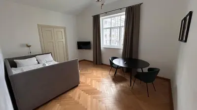 a living room with a bed and a table at Vyduno apartments 9 in Kaunas