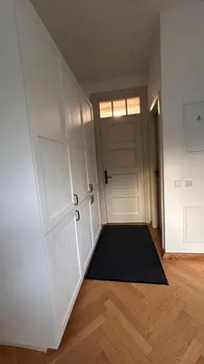 an empty room with a door and a black rug at Vyduno apartments 7 in Kaunas