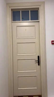 a white door with a window on top of it at Vyduno apartments 7 in Kaunas