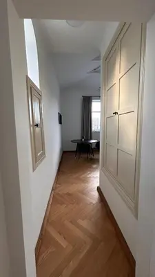 a hallway with a door and a table in a room at Vyduno apartments 7 in Kaunas