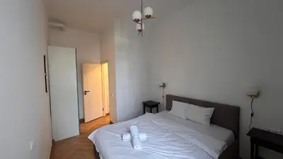 a bedroom with a white bed in a room at Italian Embassy Suites 3 in Kaunas
