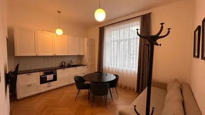 a kitchen with a table and chairs in a room at Italian Embassy Suites 3 in Kaunas