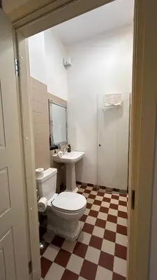a bathroom with a white toilet and a sink at Historic Embassy Apartments 1 in Kaunas