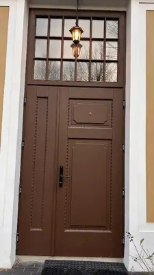 a brown garage door with a light above it at Historic Embassy Apartments 1 in Kaunas