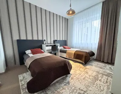a hotel room with two beds in a room at XXL apartamentai su nemokamu parkingu in Šiauliai