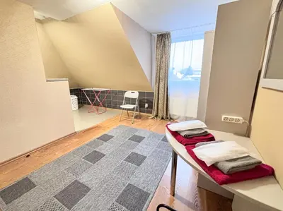 a small room with a table and a window at L apartamentai su nemokamu parkingu in Šiauliai