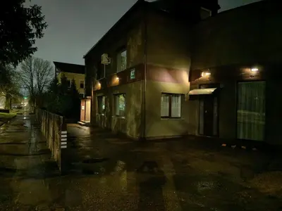 a building on a street at night at L apartamentai su nemokamu parkingu in Šiauliai