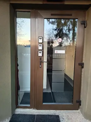 a glass door with a view of the water at L apartamentai su nemokamu parkingu in Šiauliai