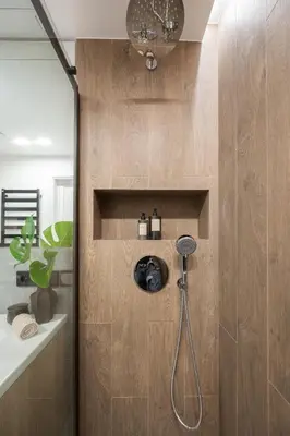a bathroom with a shower with a shower head at Modern cozy apartment with free parking in trendy Paupys in Vilnius