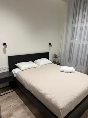 a bed with two pillows on it in a bedroom at Modern apartment near old town in Kaunas